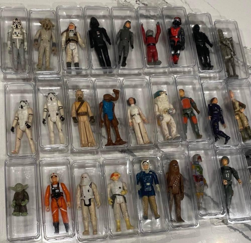 Vintage Kenner Star Wars action figures — Yoda, Chewbacca, Boba Fett, Han, Leia and more — each in protective cases